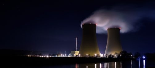 Steam billows from a power plant against a night sky. Photo - Pixabay.