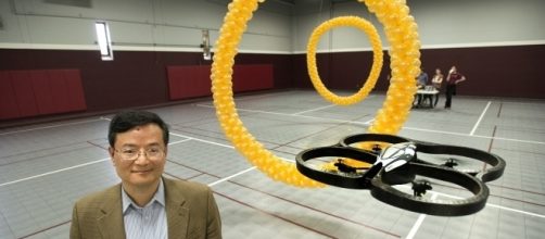 Professor Bin He in working on brain-controlled robots. (Photo via Phys.org)