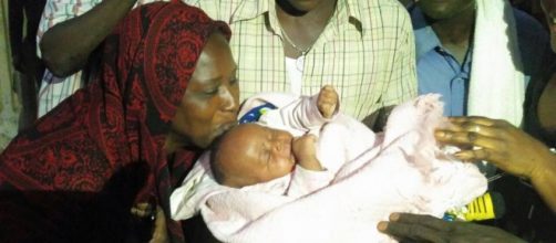 Baby Aisha Fatty being kissed outside / Sam Phatey, SMBC NEWS