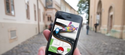 Playing the Pokemon Go app while hitting the streets.