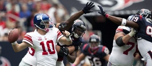 Eli Manning lining up a pass - Image AJ Guel via Wikimedia Commons