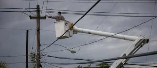 Electric company repairing a power pole in Puerto Rico (Image credit &ndash; Andrea Booher &ndash; Wikimedia Commons)