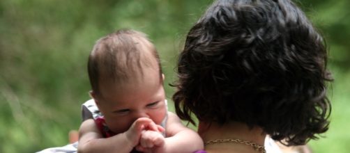 Mother carrying baby. [Image Credit: Quinn Dombrowski/Flickr]