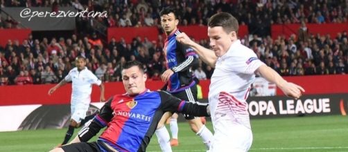 Basel midfielder Taulant Xhaka (Right) tackles Sevilla striker Rami Gameiro in a past match. (Image Credit: Perez-Ventana/Flickr)