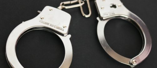 Simpson can't stay out of trouble. [image source: Jobs for Felons Hub/Handcuffs with black background/Flickr]