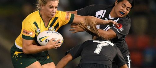 Australia captain Ruan Sims fends off two New Zealand players. Image Source: abc.net.au