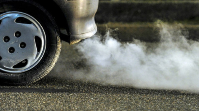 Un'auto sulla strada e lo smog