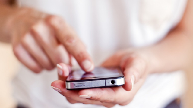 Una ragazza con in mano un telefono
