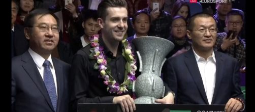 Mark Selby with the trophy in China holding a cheque for &pound;150,000