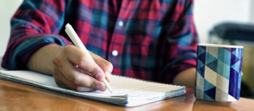 Person writing -- Daniel Foster/Flickr.