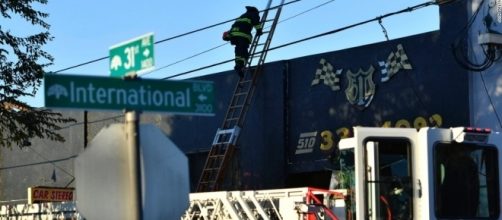 An Oakland firefighter climbs to the roof of the building that housed the Ghost Ship warehouse in Oakland, Calif., where 36 died. (Photo: CNN.com)