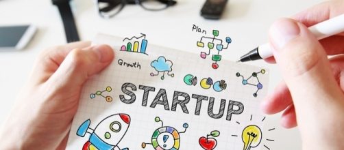 Mans Hand Drawing Startup Concept on Notebook &raquo; ReachIvy - reachivy.com