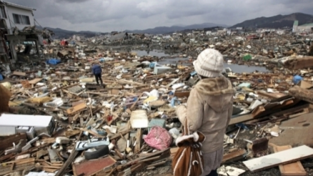 Donna che osserva il disastro causato dal maremoto in un villaggio del #Tohoku, #Giappone,