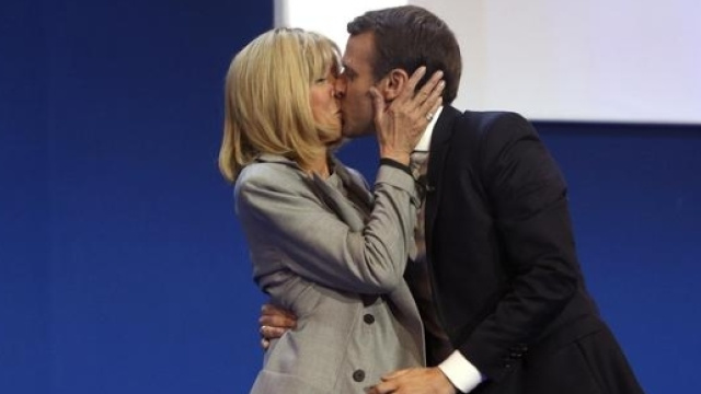 Inseparabili: il candidato alla presidenza della Francia, Emmanuel Macron bacia sul palco la moglie Brigitte di 24 anni pi&ugrave; grande di lui. Foto: Ansa.