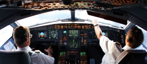 Pilot and co-pilot in cockpit.