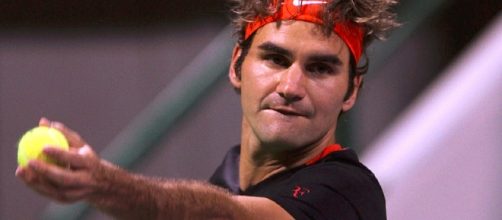 Swiss tennis ace Roger Federer serves/ Image creative common wiki via Vinod Vakaran www.dohastadiumplusqatar.com