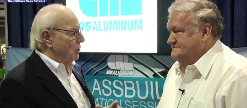 Lyle Hill talks with Donald Friese of C.R. Laurence. Photo via USGlassMag, YouTube.