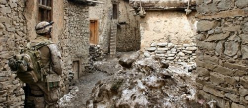 US marine surveys a Afghan village.https://pixabay.com/en/marines-afghanistan-war-soldier-60540/