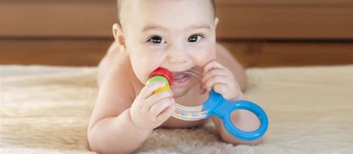 A baby with teether (Image Source: YouTube/Babies Wiki)