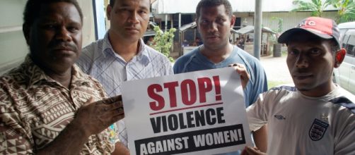 Live and Learn staff pose with a &lsquo;Stop! Violence against women&rsquo; sign - Image Department of Foreign Affairs and Trade | CC BY 2.0 | Flickr