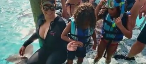Mariah Carey and her twins recently went on a private island and swim with nurse sharks. Image via YouTube/CelebrityUpdate