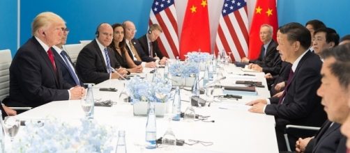 President Trump sitting across Chinese President Xi Jinping at G20 / [Image by TheWhiteHouse via Flickr, Public Domain]