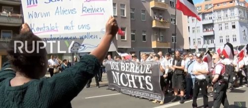 A counter-protester stands against a group of neo-Nazis in Spandau, Berlin [Image: YouTube/Ruptly TV]