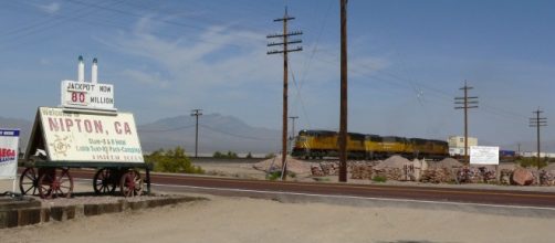 View of Nipton, California, with freight train passing through | Stan Shebs via Wikimedia Commons