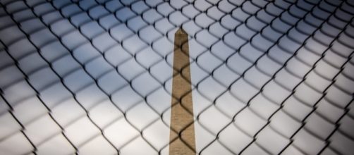 Washington Monument behind a fence in D.C. / [Image by M01229 via Flickr, CC By 2.0]
