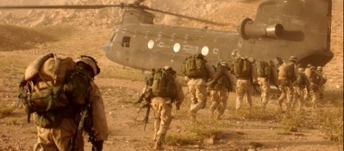 Soldiers march to the ramp of the CH-47 Chinook helicopter on Sept. 4, 2003 by Staff Sgt. Kyle Davis via Wikimedia Commons