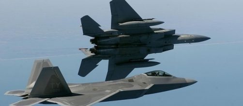 An F-15 Eagle and an F/A-22 Raptor in flight (Credit - Ben Bloker &ndash; wikimediacommons)