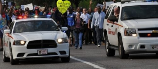 Police in Ferguson, MO where another officer involved shooting occured https://commons.wikimedia.org/wiki/File:Ferguson,_Day_4,_Photo_25.png