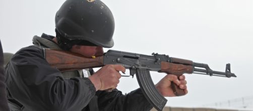 An Afghan uniformed police officer fires his AK-47 rifle.Source;commons.wikimedia.org
