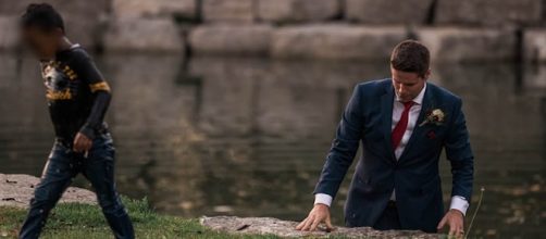 A Canadian couple was enjoying their wedding shoot when the groom rescued a young boy from a nearby pond [Photo: YouTube/1010 Wins]