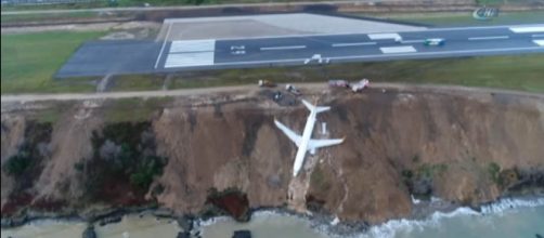 A Turkish passenger jet had problems landing and skidded off the runway, hanging from a cliff [Image credit: Ihlas News Agency/YouTube]