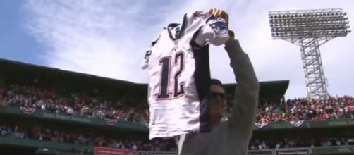Tom Brady shows the stolen jersey to Boston Red Sox fans after it was recovered (Image Credit: MLB/YouTube)