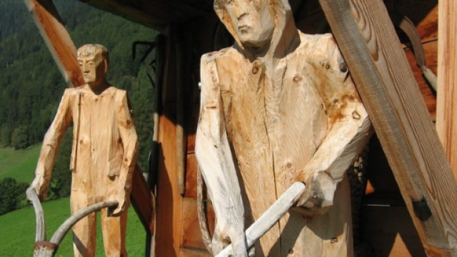 Sculture di legno visibili davanti ad alcune case in Val Aurina