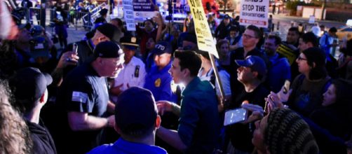 Trump supporter (left) and protestor (right) debate &ndash; Image Credit &ndash; Alec Perkins | Wikimedia Commons.