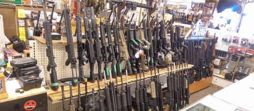 Assault rifles, mostly AR-15's, in a shop in Salt Lake City, Utah (Image credit &ndash; Michael McConville, Wikimedia Commons)