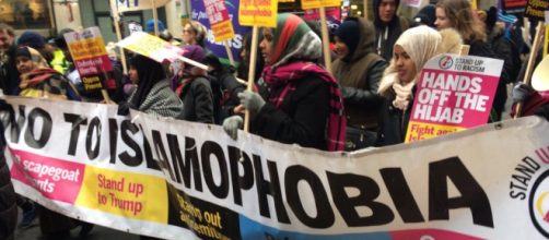 A photo from Glasgow's anti-racism march of Scottish Muslims holding a 'No To Islamophobia' Sign. Photo Credit: www.standuptoracism.org.uk