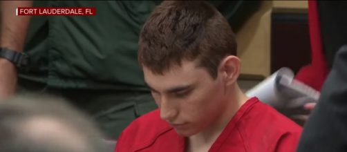 Nikolas Cruz kept his head down through the hearing. [image source: youtube/CNN]