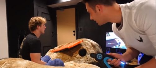 Logan Paul playing 'Fortnite' while being distracted by Andy Altig. - [Logan For Life / YouTube screencap]