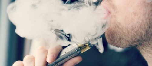 Man smoking from an e-cigarette (Image via JoyCy/Flickr)