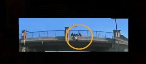 Trucks line up under highway bridge to save jumper. Photo: CBS News/YouTube screenshot