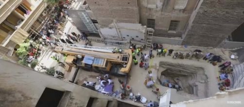 A massive black granite sarcophagus was discovered on a construction site in Alexandria. [Image Guardian News/YouTube]
