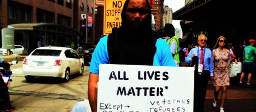 A man protests Donald Trump's treatment of immigrants and other marginalized groups in downtown Cleveland, Ohio. [Photo by Ashley Herzog]