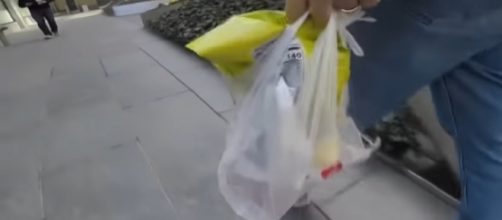 NY to ban plastic bags & charge traffic tax. [Image source/RT America YouTube video]