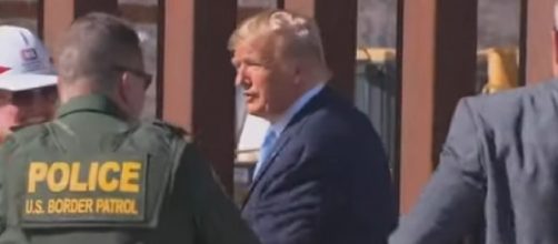 Trump signs name on Mexico border wall. [Image source/Associated Press YouTube video]