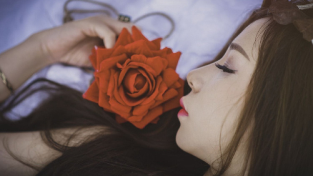 Donna sognante con rosa scarlatta - &copy; Pixabay.