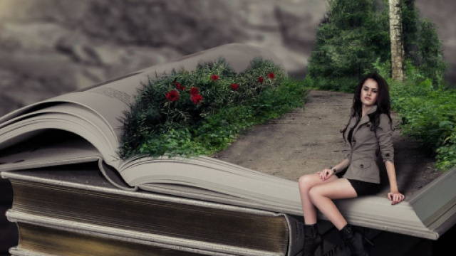 Donna seduta su un libro aperto addobbato a stradina di campagna - &copy; Pixabay.